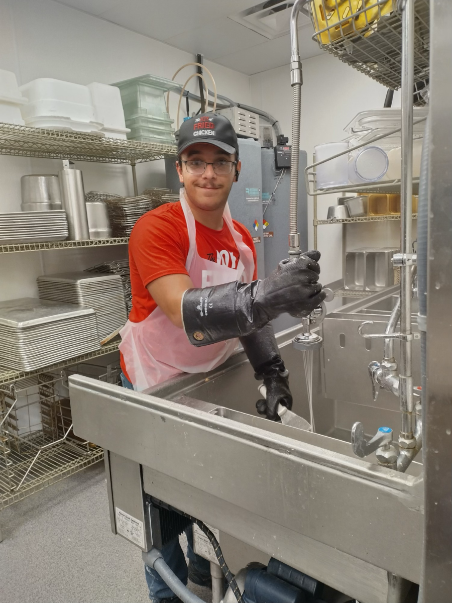 Senior Joseph Houk cleaning at his workplace, KFC. He explained he was, "closing up and making sure that all of the sinks were completely clean for the morning crew." By doing so, he ensured that there was less for the morning shift to do the next day. Photo provided by Joseph Houk, used with permission.