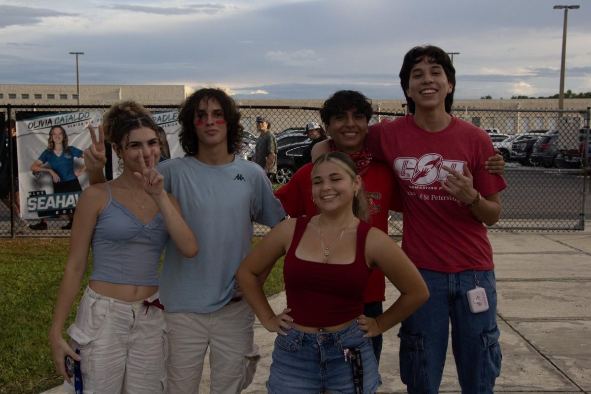 Mariano Quiroga, Senior; with some of his friends at the football game. He is the one on the middle right. He is wearing a red shirt representing the American colors, as the theme for the game was American colors.
