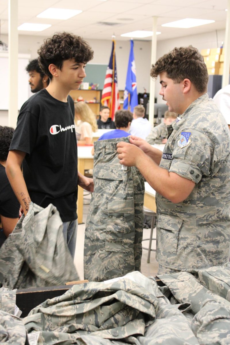 Westley Swank passing out CAP uniforms to new recuits.