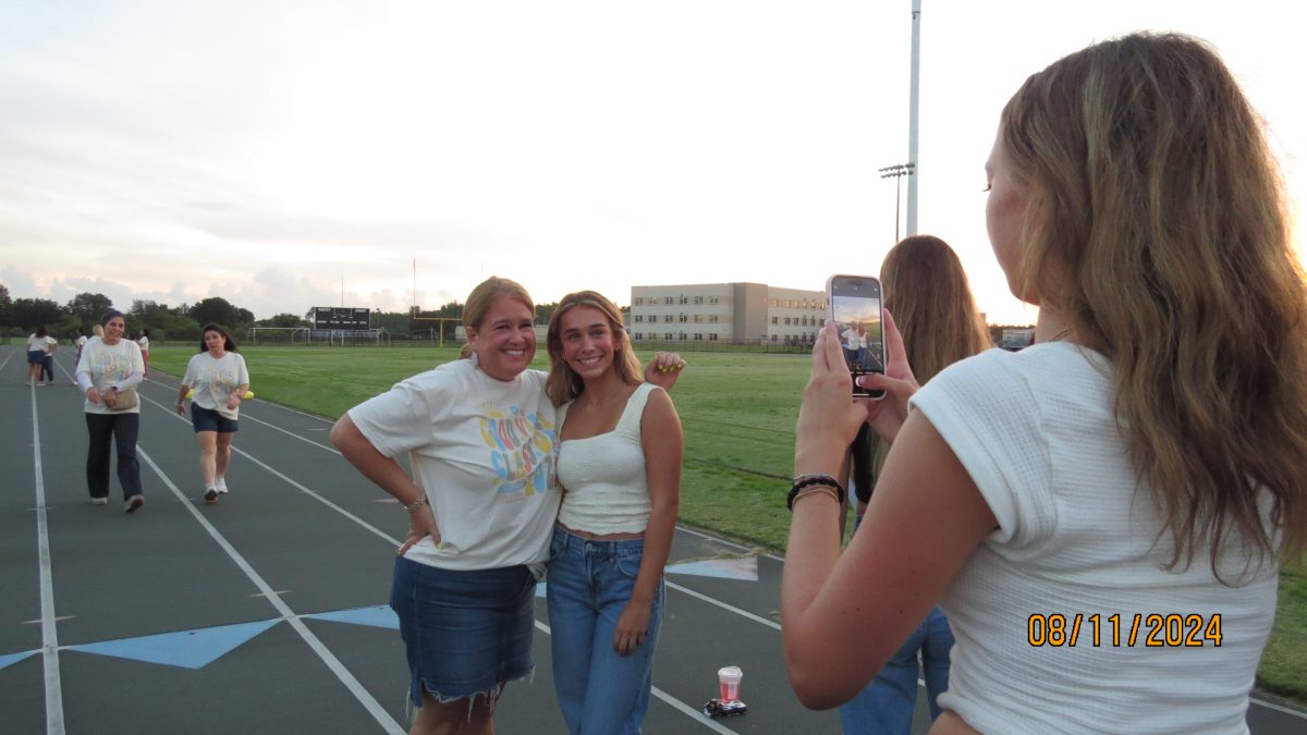 Isabella Becker and her Mom posing for a picture the morning of Senior Sunrise. 