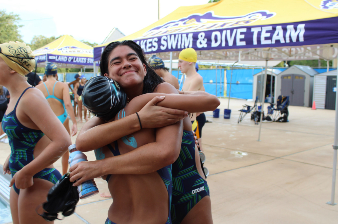 Mia Martin hugging her friend in swim.