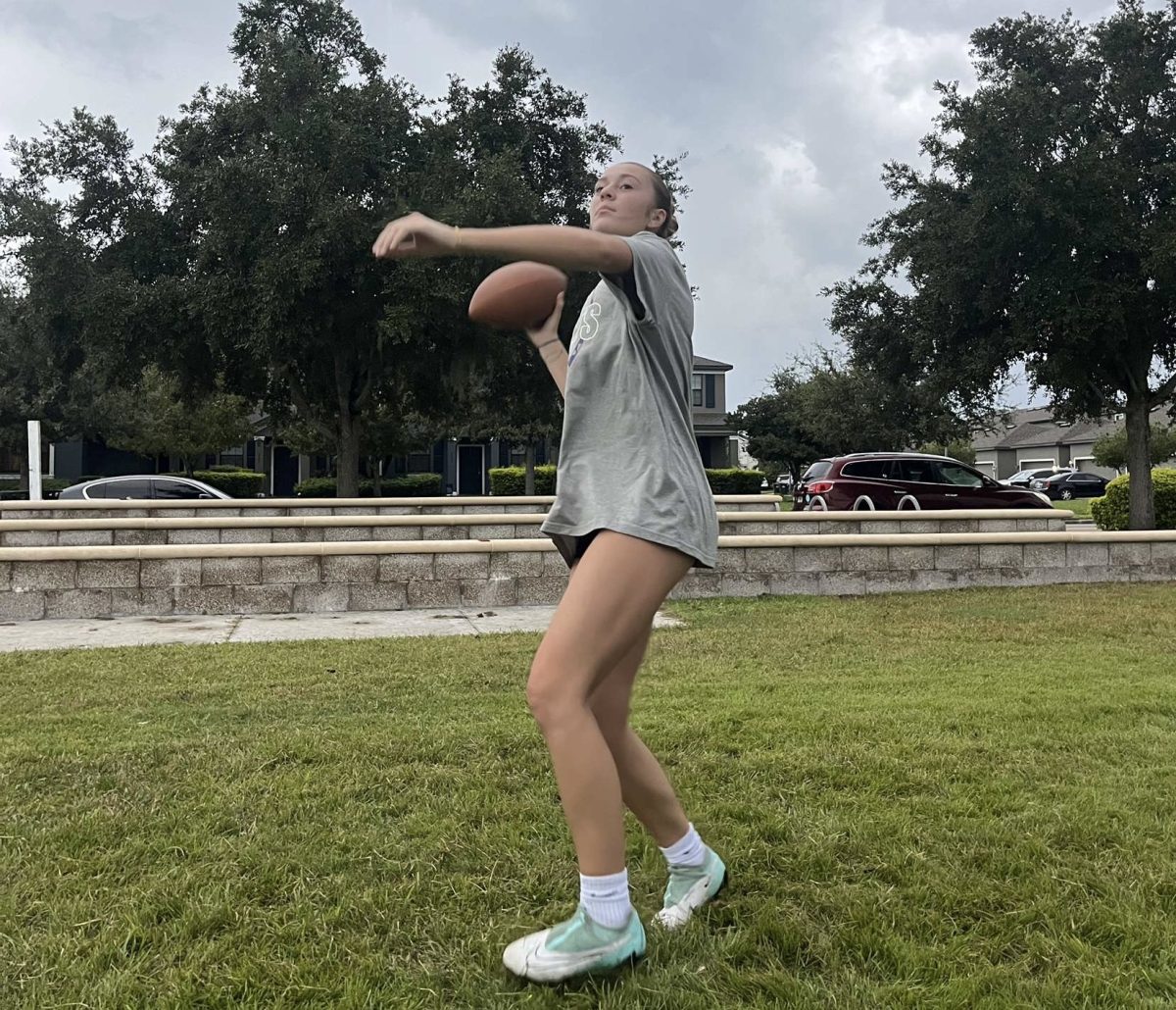 Senior Elephteria is seen throwing the football at powderpuff practice. Ella says how excited she is for this years game.