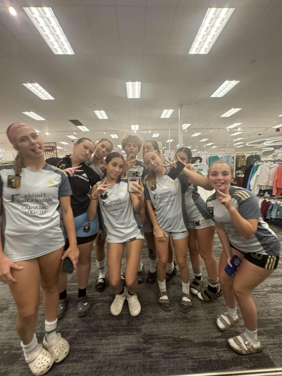 Sophomore Kayleigh Karr taking a picture with her soccer team over Labor-Day weekend.