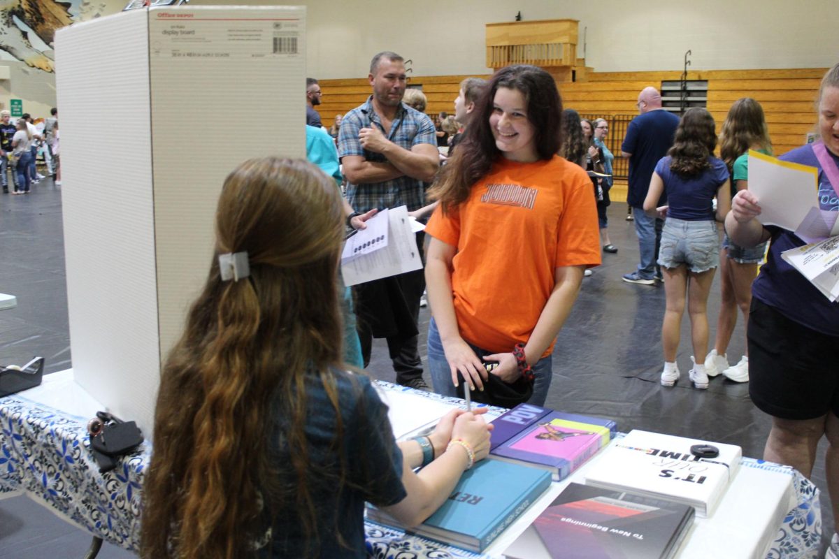 Alexia Slaga, Freshman; at Freshman Orientation. She is learning about the school's yearbook, and how she can go about buying one. 