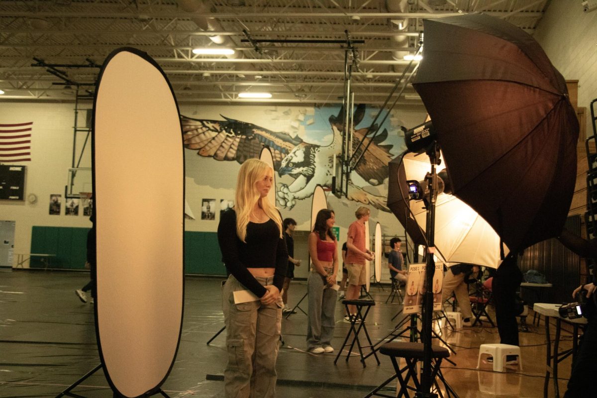 Junior Elise Laari getting her photo taken in Sunlake's gym on Picture Day. 