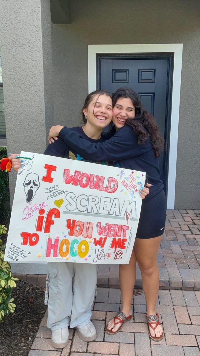 Madison taking a picture with her best friend Abigail after asking her to Homecoming. She loved being able to go enjoy the night with her best friend.  The proposal gave them a great memory together, dancing the night away.