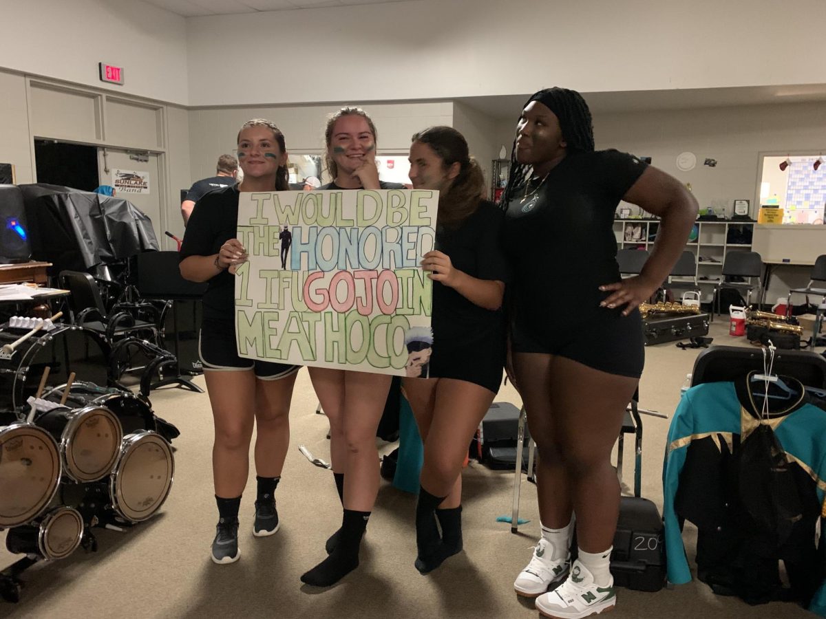 Friends Megan Olson (12th grade), Alina Diaz (12th), McKinley Cassels (12th), and Madison Williamson (10th) posing together after a successful Homecoming proposal to Olson.