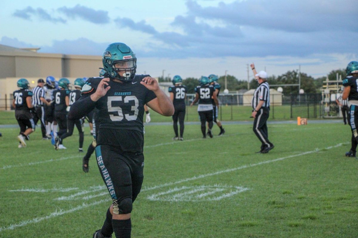 Trenton walking in the sunlake football uniform