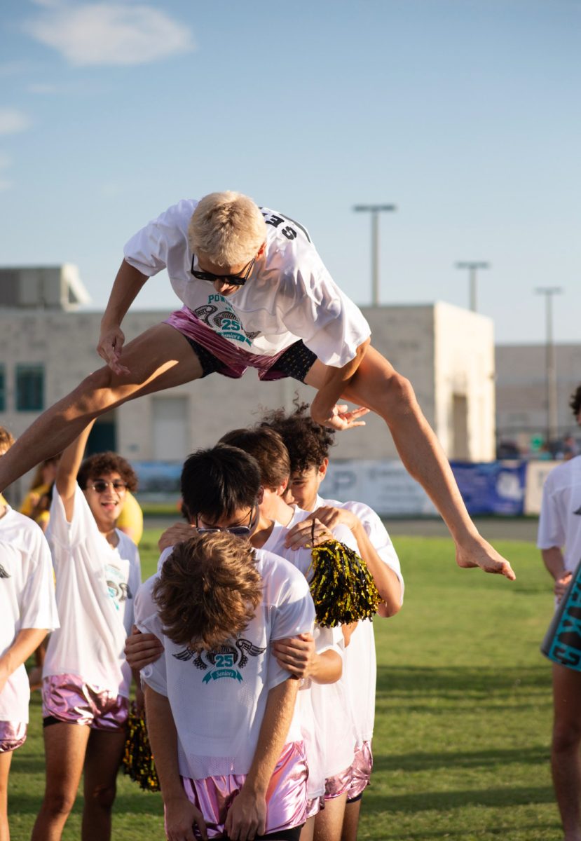 George Clark is seen in this photo. he finished powderpuff by jumping over some of his friends. "i do long jump competitively so jumping over them was easy for me."