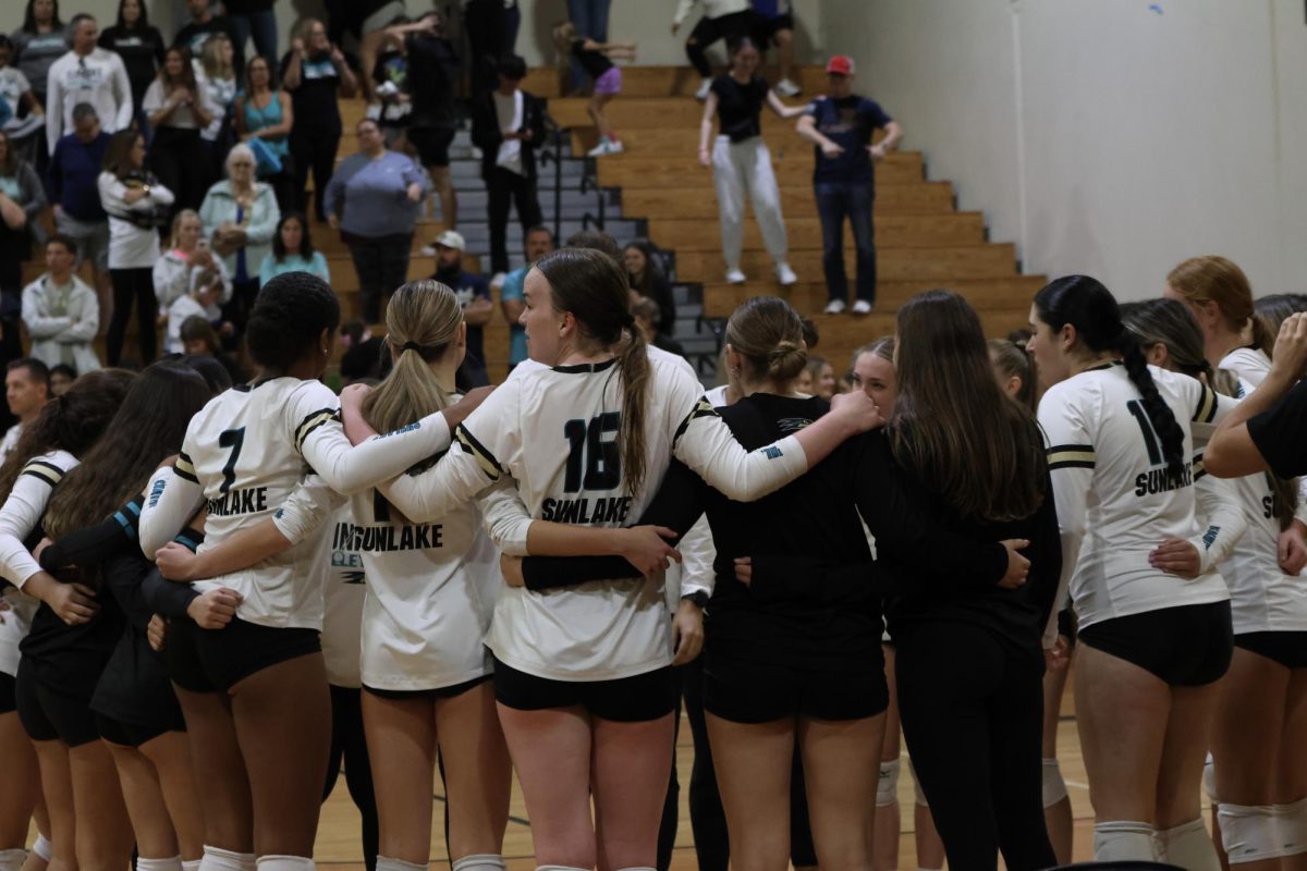 Junior Lillian Gaskins (Black uniform, bun) celebrating with her teams successful night at regionals. "Even though I couldn't be in the game, I was there to support my teammates, and it was a lot of fun."