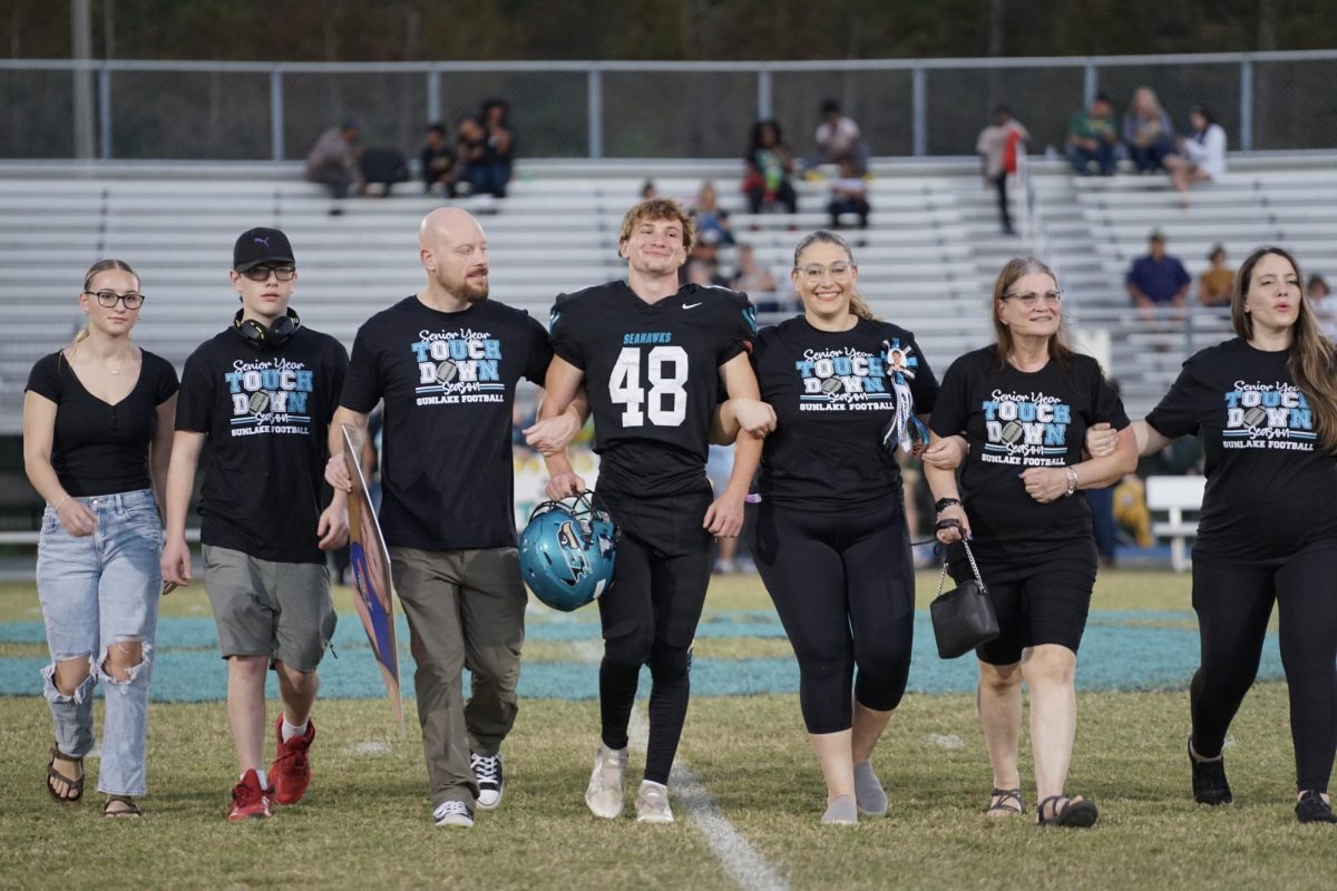 Matthew Gorden, senior, and his family walking onto the football field to celebrate Sunlake's senior night. 11/1/24