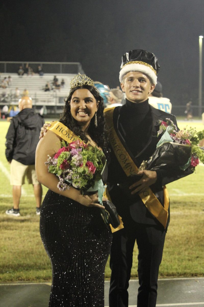 Senior Lynn Raad and George Clark at the homecoming game after being crowned  Homecoming Queen and King.