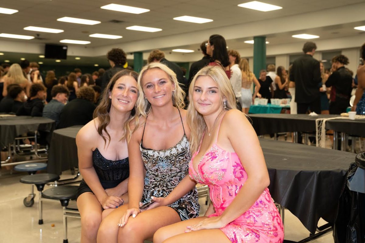 Shelby Kerr (Pink Dress), posing for a picture with her friends at the homecoming dance.