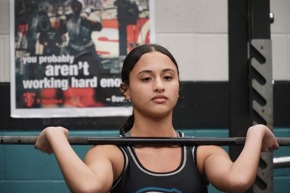 Senior, Heidimar Rivera during her weightlifting meet. This is Heidimar's second year on the team. Heidimar states, "I competed to the best of my abilities and I pushed myself especially for clean and jerk."