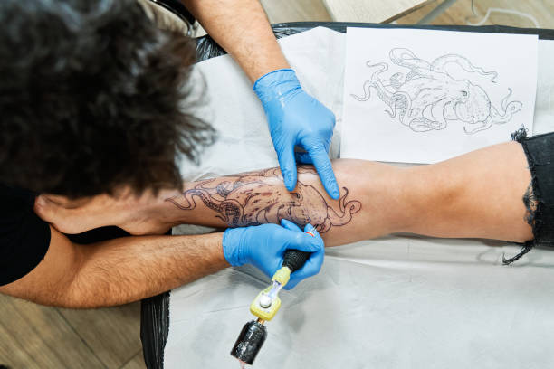 ("Artist Tattooing", Getty Images)