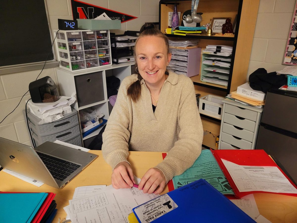 Mrs. Shea, a 9th grade math teacher, sitting at her desk. 