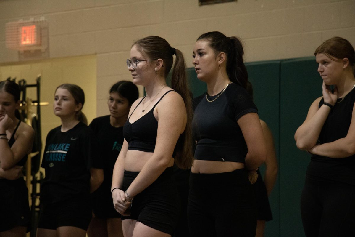 Haylie listening to her coach giving instruction at a rehearsal.