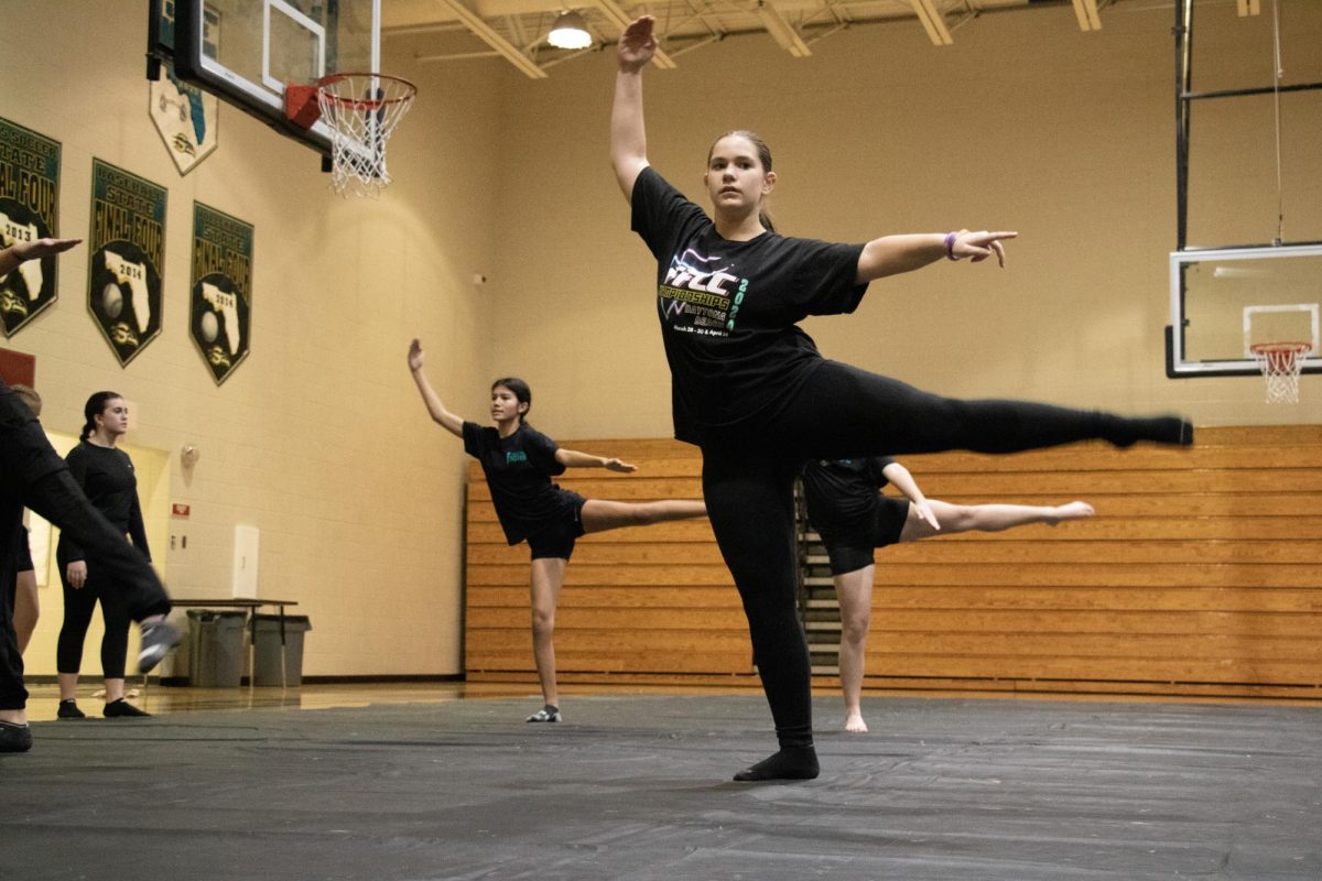 During her winter guard practice, Lucy Butler. Here, they are improving their technique and skills by rehearsing floor progressions.