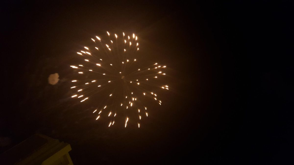 A vibrant trail of fireworks moving across the sky.