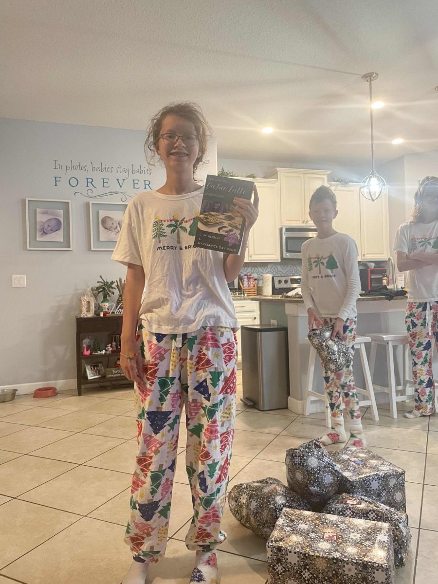 Grace Dreznes (9th) on Christmas morning, seen here posing with her Christmas presents.