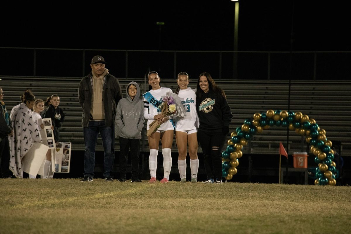 Madylena Perez alongside her family during halftime on her senior night at the Sunlake stadium. 