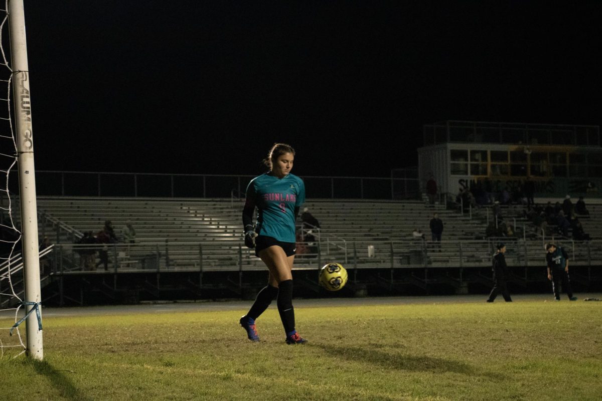 Katie is in the middle of the game defending the net. She says that she is, "very proud of the team." 