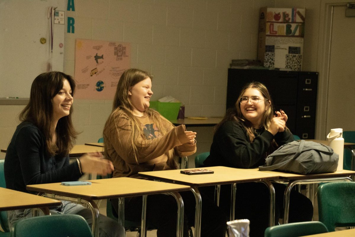 Senior, Giselle Alcala; Enjoying the book club meeting full of laughter and playing fun games with the other members of the club.