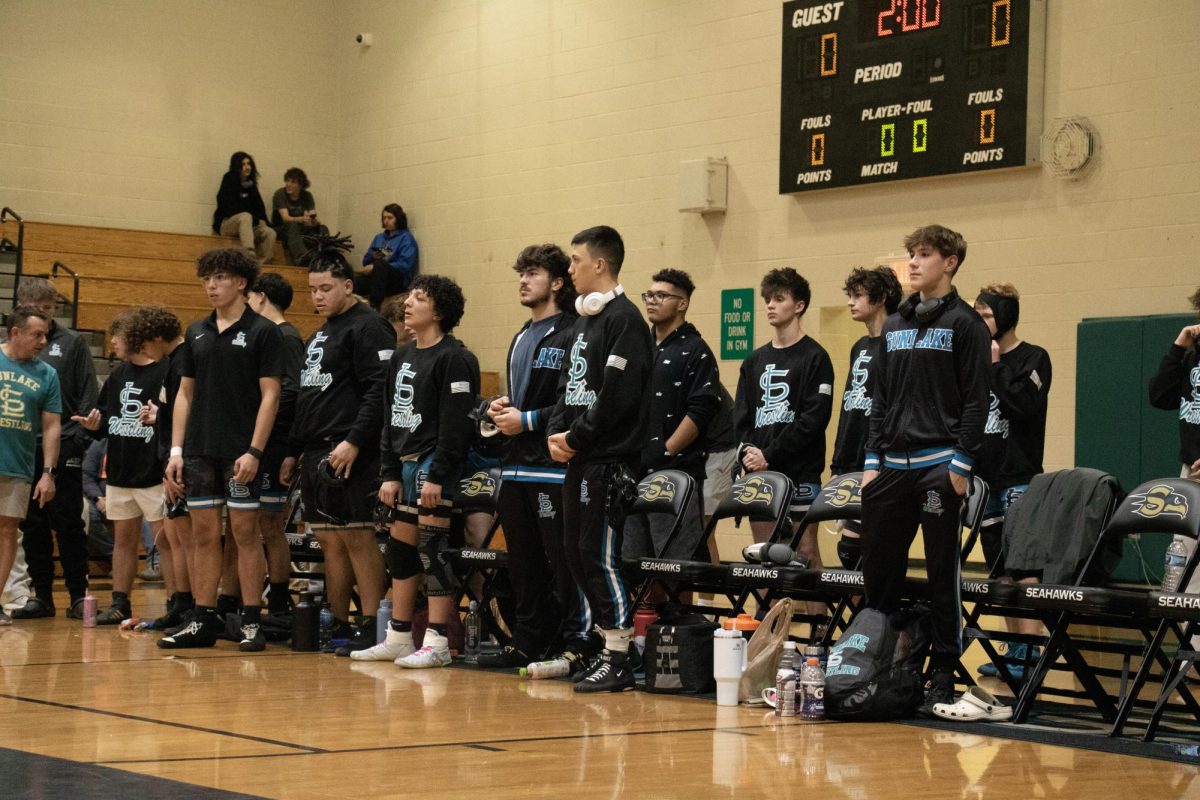 Ezekiel Johnson (far right) stood with his team mates on wrestling senior night. The night was “…really fun, I like any time I get to hang out with them is a good time” the junior stated.