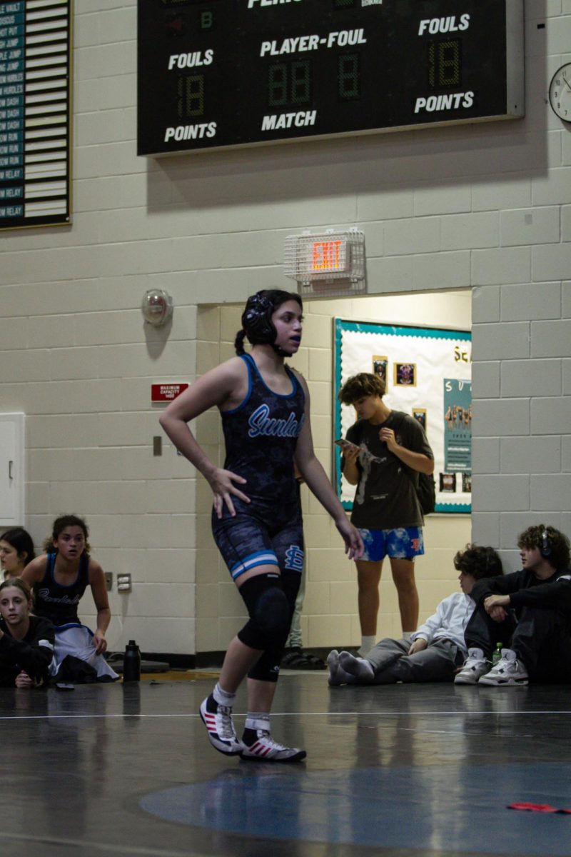 Jaylin Fuentes, Sophomore, preparing for her match against Steinbrenner. Jaylin "felt nervous and excited to wrestle" as she walked onto the mat.