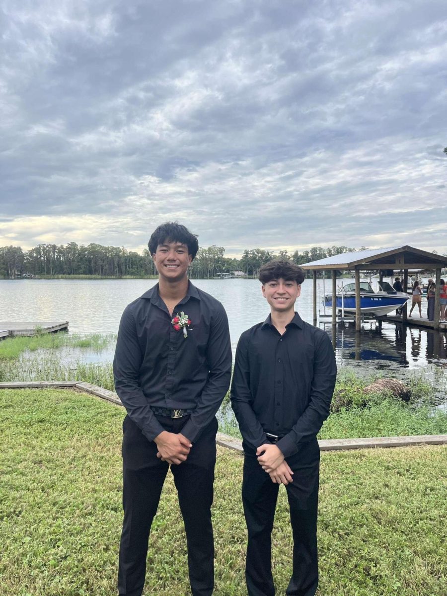 Jacob standing next to his friend, by the lake before a new years dinner.