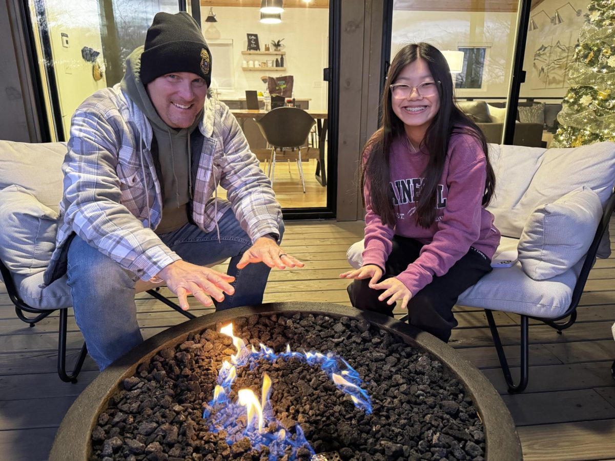 Sophomore Lila Rhodes and her dad enjoying the night by the fire in Blue Ridge Georgia.