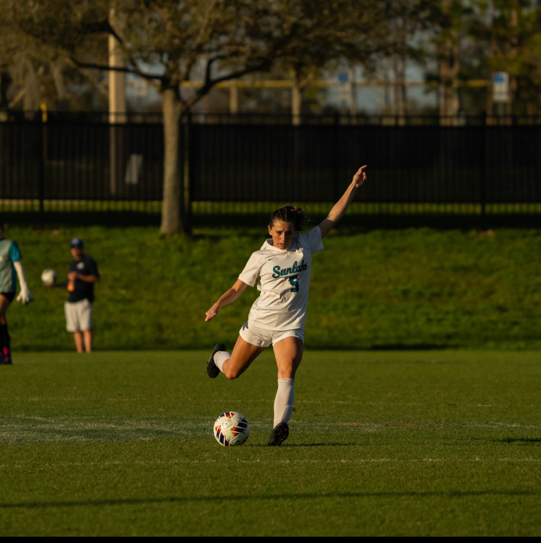 Junior, Kylie Hudgins sending the ball up the field during the states final four game.