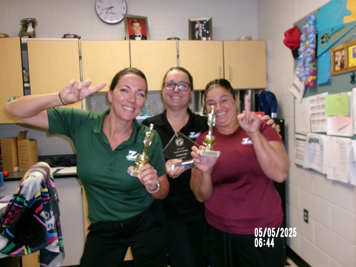 Lunch staff Kara Rumsey, Amy Button, Camille Michiell posing in the back office.