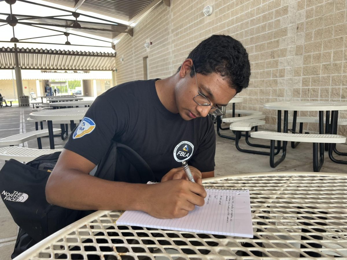 Manikandan Venkata, Senior; Working on FBLA work and preparing for his presentation to the members.