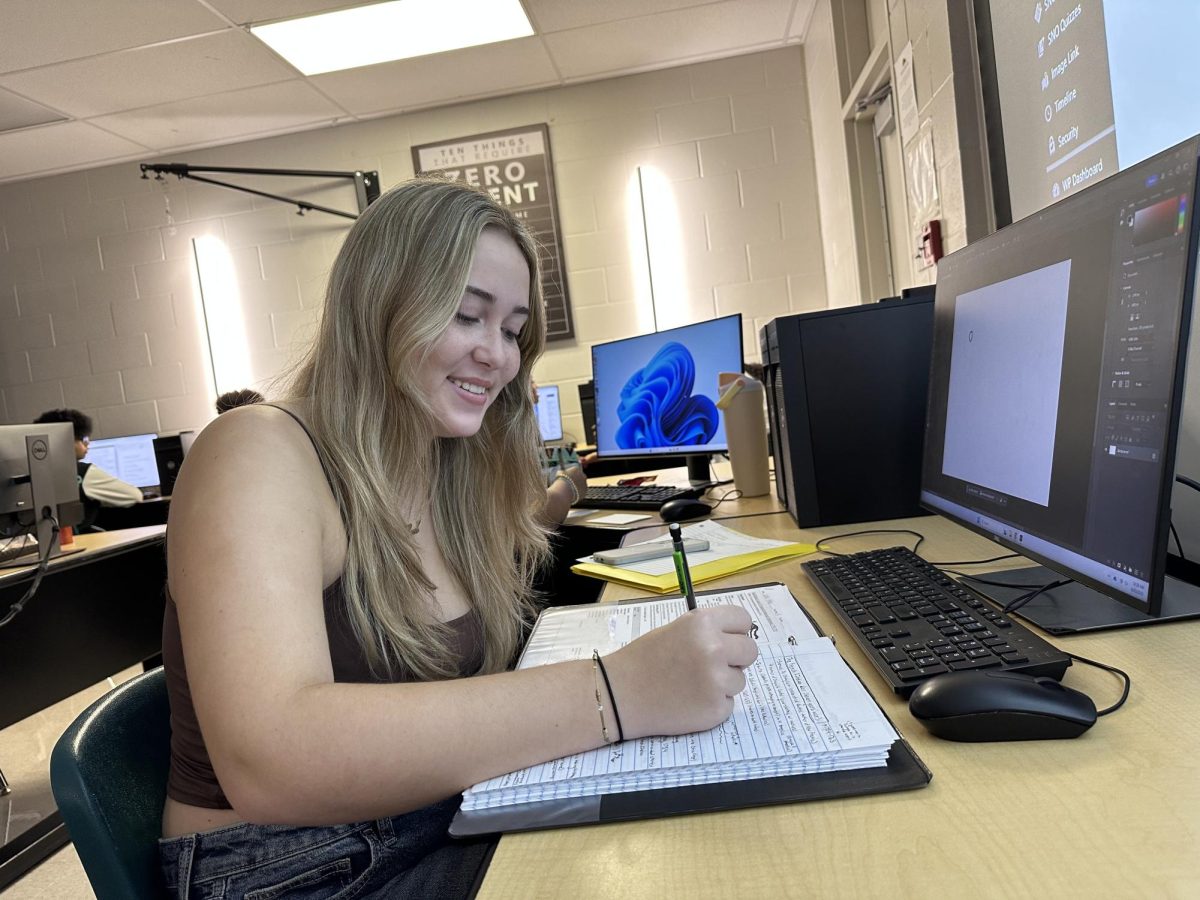 Lexi Vitale; Junior, working on writing her first exciting new story for the yearbook. 