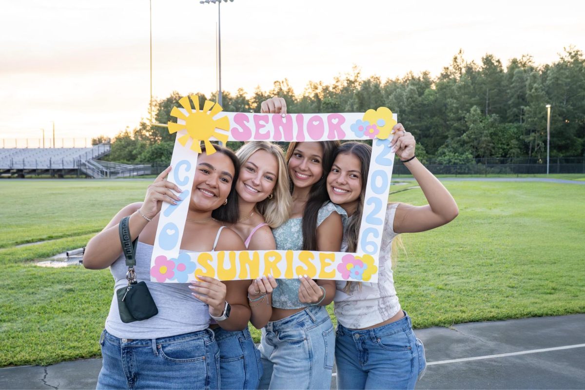 Amelia taking some more cute pictures on the field with her friends. Amelia said, "I loved capturing all the moments of senior sunrise." From left to right is Amelia Tineo, Zoey Fry, Alexandria Schopke, and Laura Victoria.