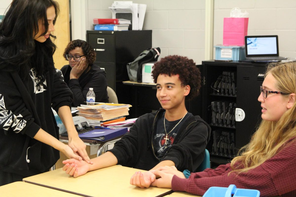Junior, Isaiah Engelhardt talking to his friends during the most recent HOSA meeting. He said, "I enjoyed it a lot."