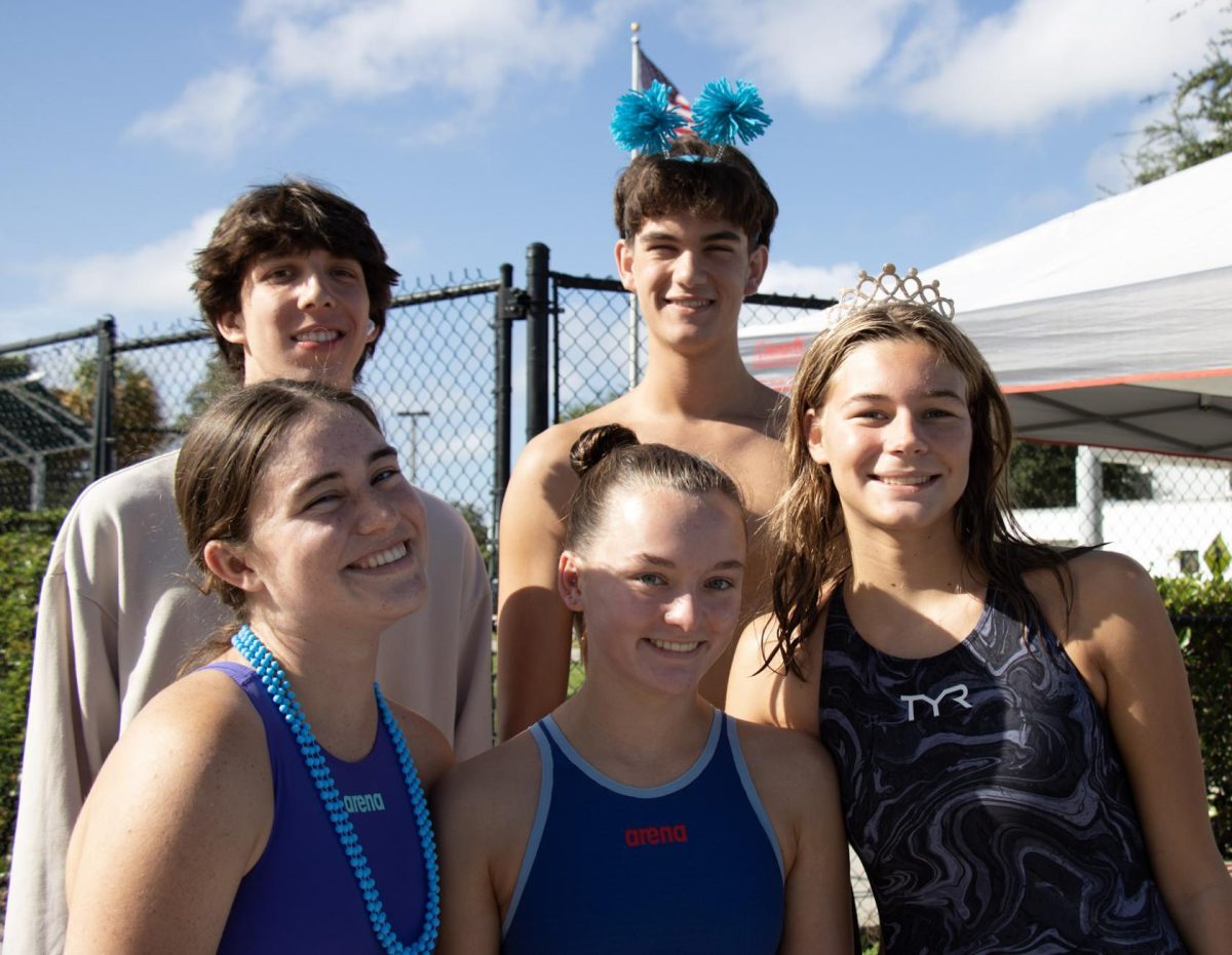 Junior Mia Fackler enjoys a swim meet with some of her teammates.