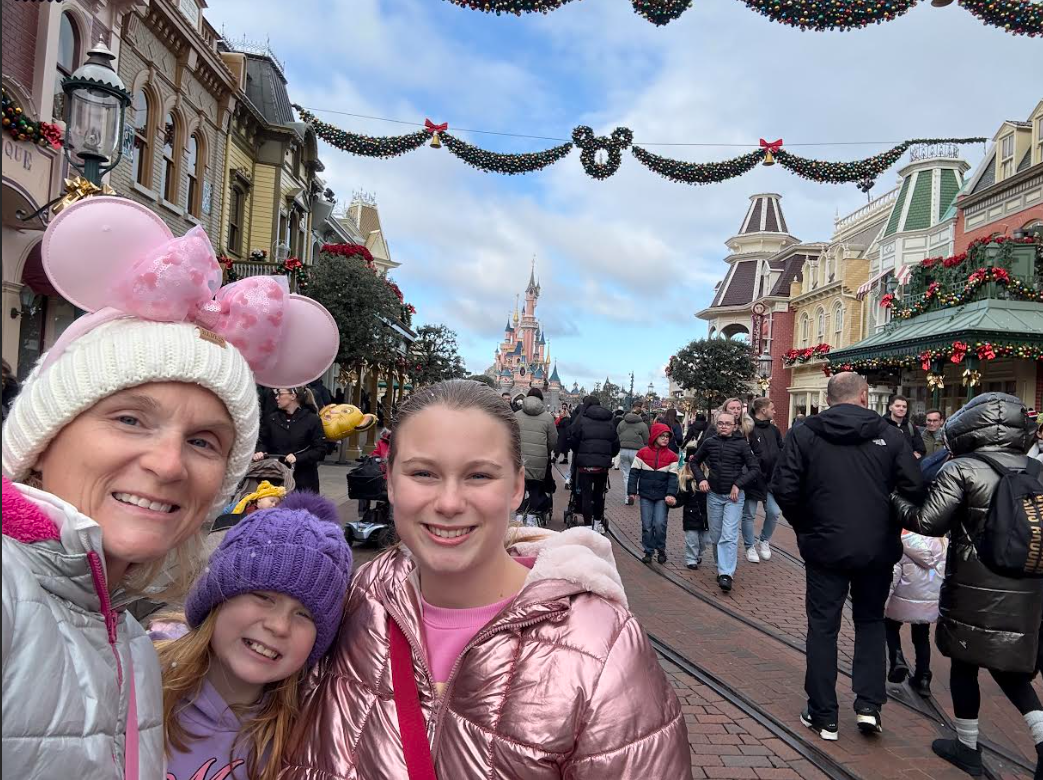 At the center of Disneyland Paris Junior Alia Collins, her mom, and little sister take a photo in front of Sleeping Beauty's castle. It was very chilly there but, the Christmas decor brought out holiday cheer. 
