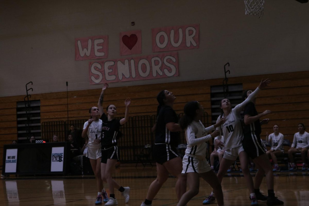 Allison and her teammates wait under the hoop as Pasco takes a shot. They're ready for anything to happen in that single moment.