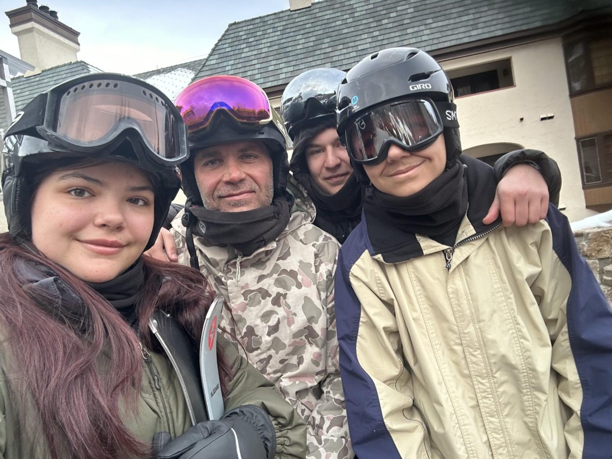 Adalie Gummoe, 9th grade, pictured with her parents and her brother Tanner Gummoe after a fun time snowmobiling.