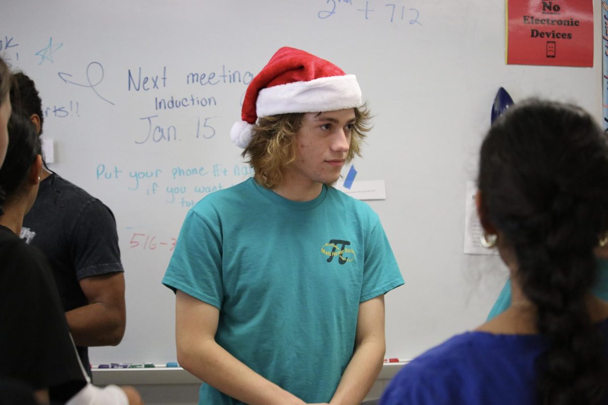 Alex Whitman; Senior, Playing the role of Santa Claus in the festive scavenger hunt that the members of Mu Alpha Theta had to solve.