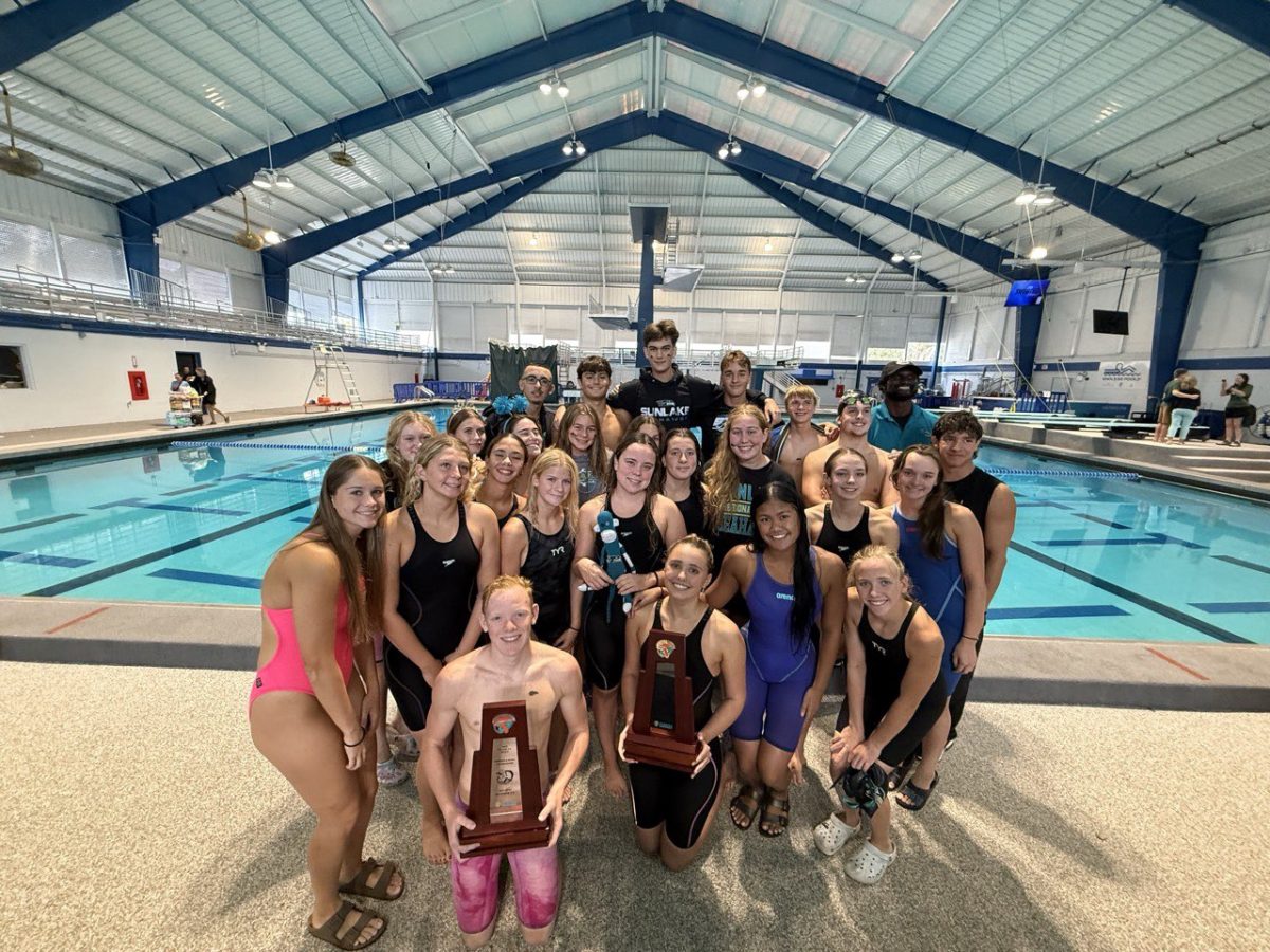 Evan (left back) enjoying a post-swim picture with his teammates.