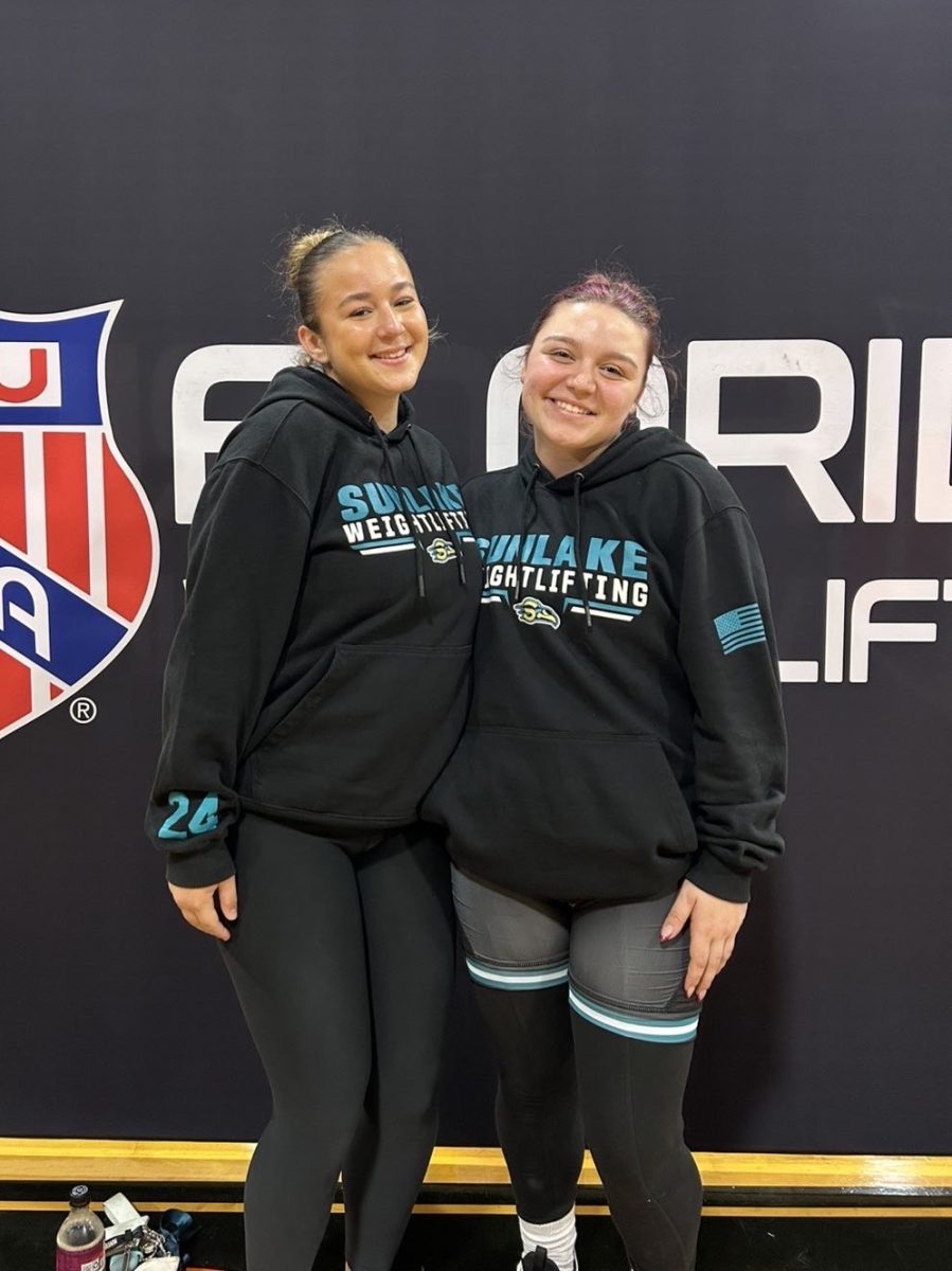 Mia and her friend, posing together after their weightlifting competition. Representing their school uniforms after competing and doing awesome in the meet.