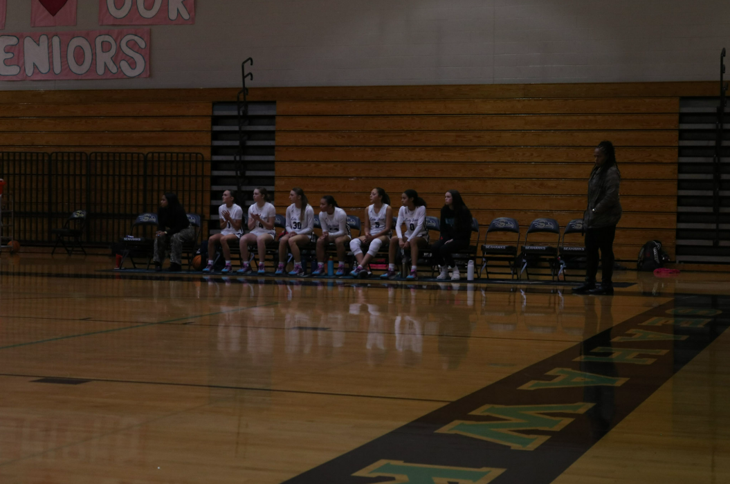 Junior Dawn Figueroa and her team on the sidelines at the girls varsity basketball game against Pasco High School, planning their next move and excited knowing that they will win.