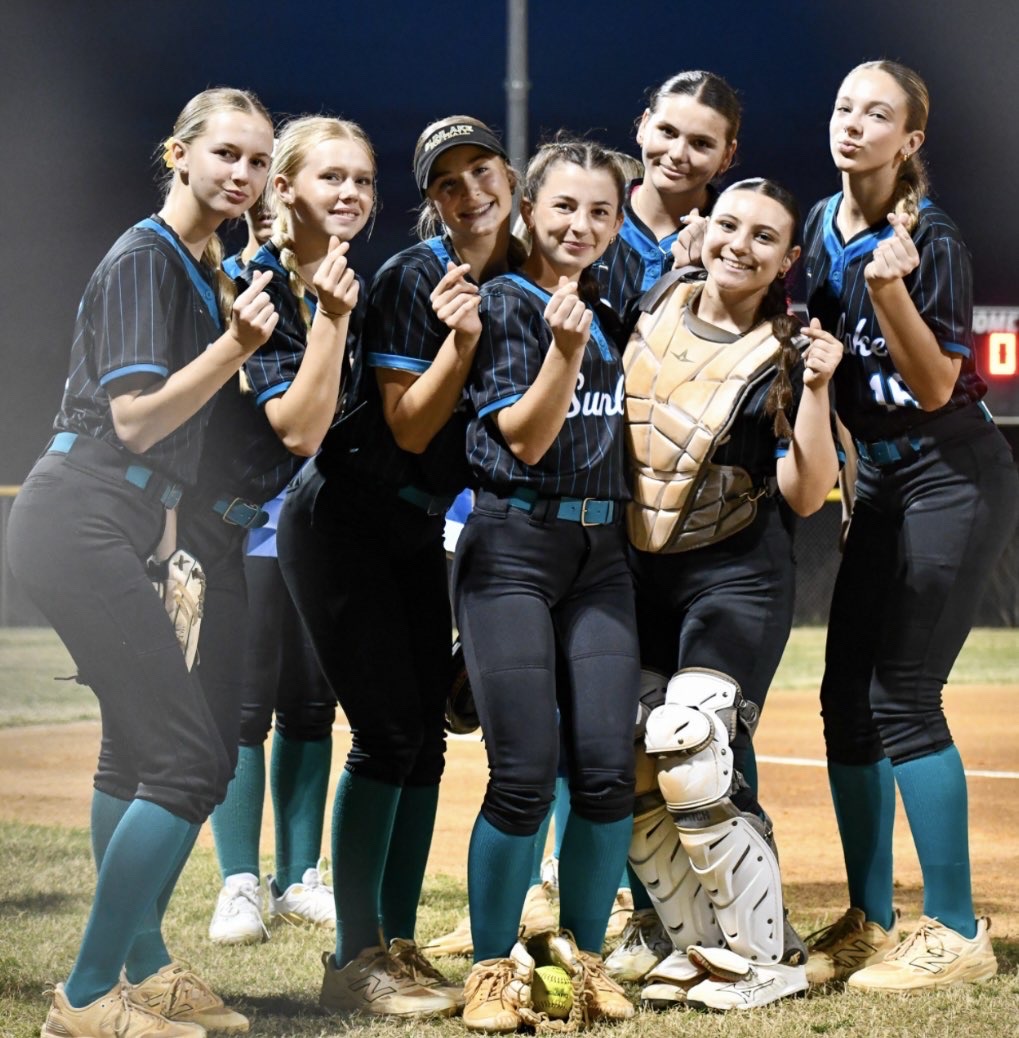They pose for a photo together and smile for the camera making sure to capture their win at the game. The players have worked hard all season and have a strong connection.